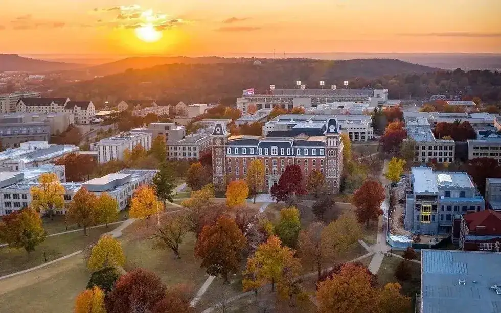 Aerial sunset view of University of Arkansas campus and Fayetteville in autumn